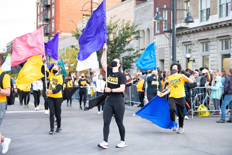 college students holding flags in parade