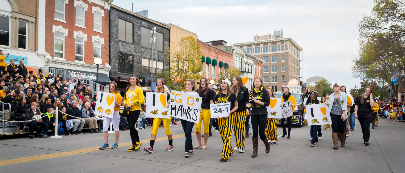 Students marching in street during the homecoming parade