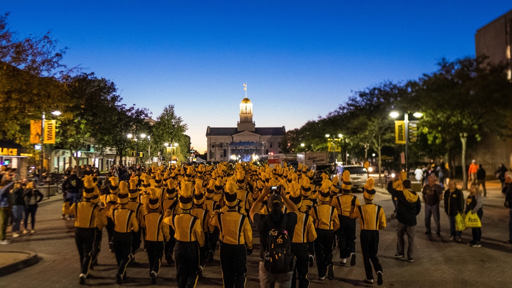 A picture of the Hawkeye Marching Band approaching the Old Capitol Building after the 2021 Homecoming Parade.