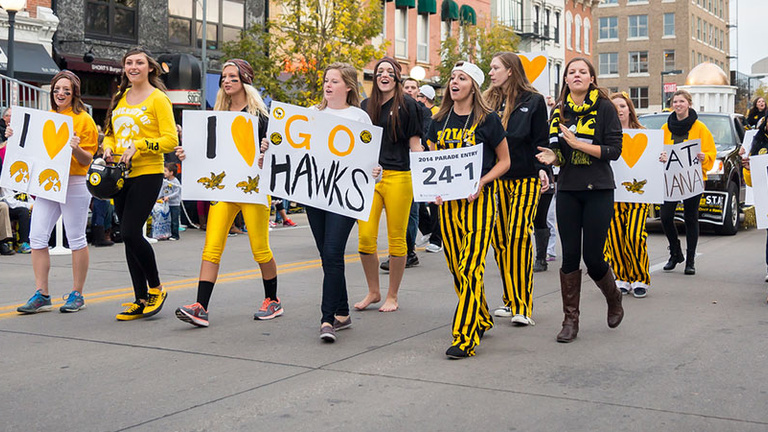 People marching in the street in the Homecoming Parade